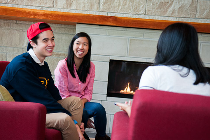 UBC residents gather near the fireplace in the Marine Drive residence Commonsblock.