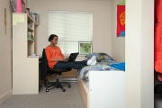 UBC Fraser Hall resident uses a laptop in her private bedroom.
