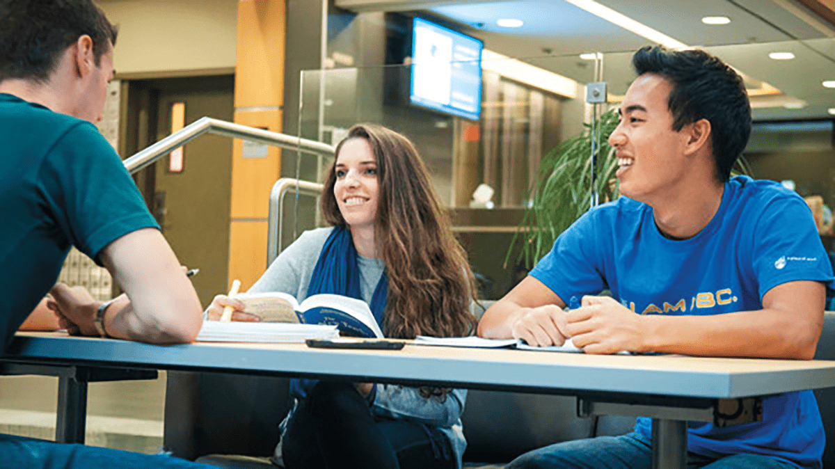 Group of students studying together in library